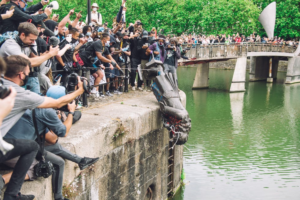 the statue of colston is pushed into the river avon edward colston was a slave trader of the late 17th century who played a major role in the development of the city of bristol, england, on june 7, 2020 photo by giulia spadaforanurphoto via getty images