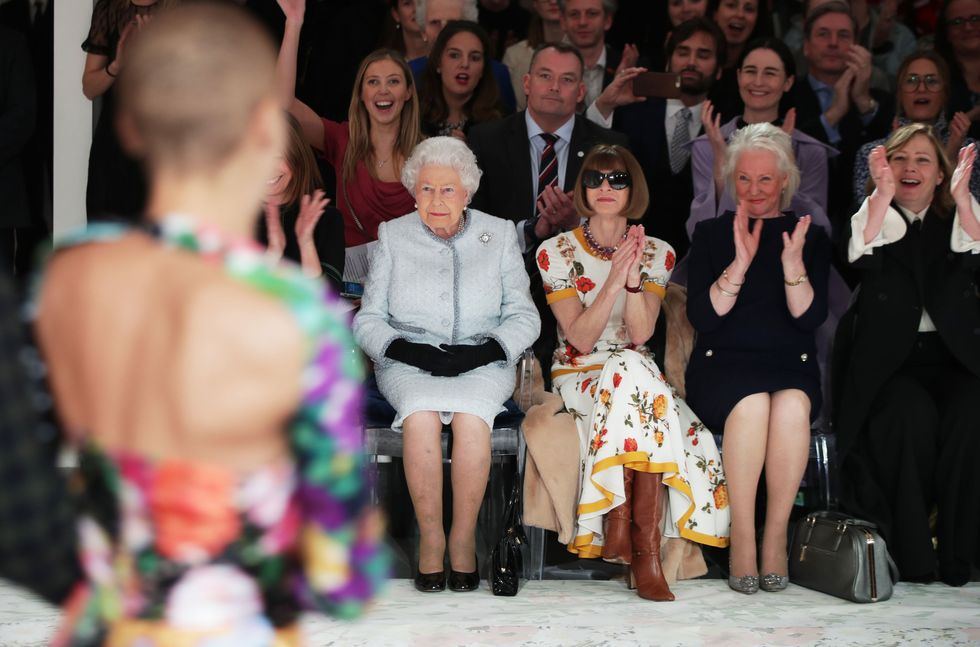 Queen Elizabeth, Anna Wintour (center left), and Angela Kelly (center right) attend a fashion show