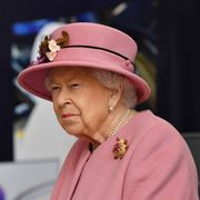 queen elizabeth wearing a pink hat, coat, and no mask for her first outing during the covid 19 pandemic