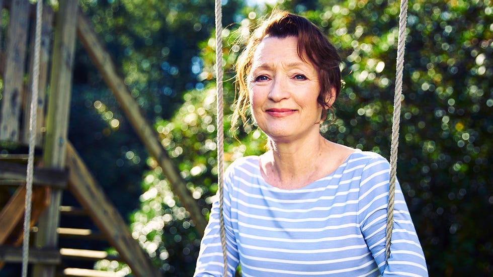 adult woman sitting on a swing in a natural outdoor setting