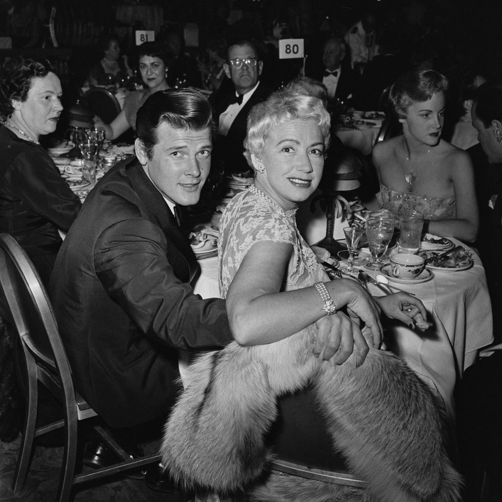 british actor roger moore (1927 2017) and his wife, british singer dorothy squires (1915 1998), attend an event, united states, circa 1955. (photo by al morch/graphic house/archive photos/hulton archive/getty images)