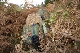 a british army sniper team dressed in ghillie suits