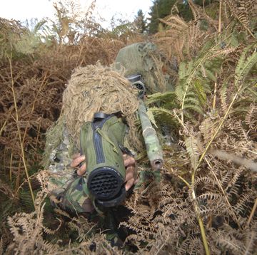 a british army sniper team dressed in ghillie suits