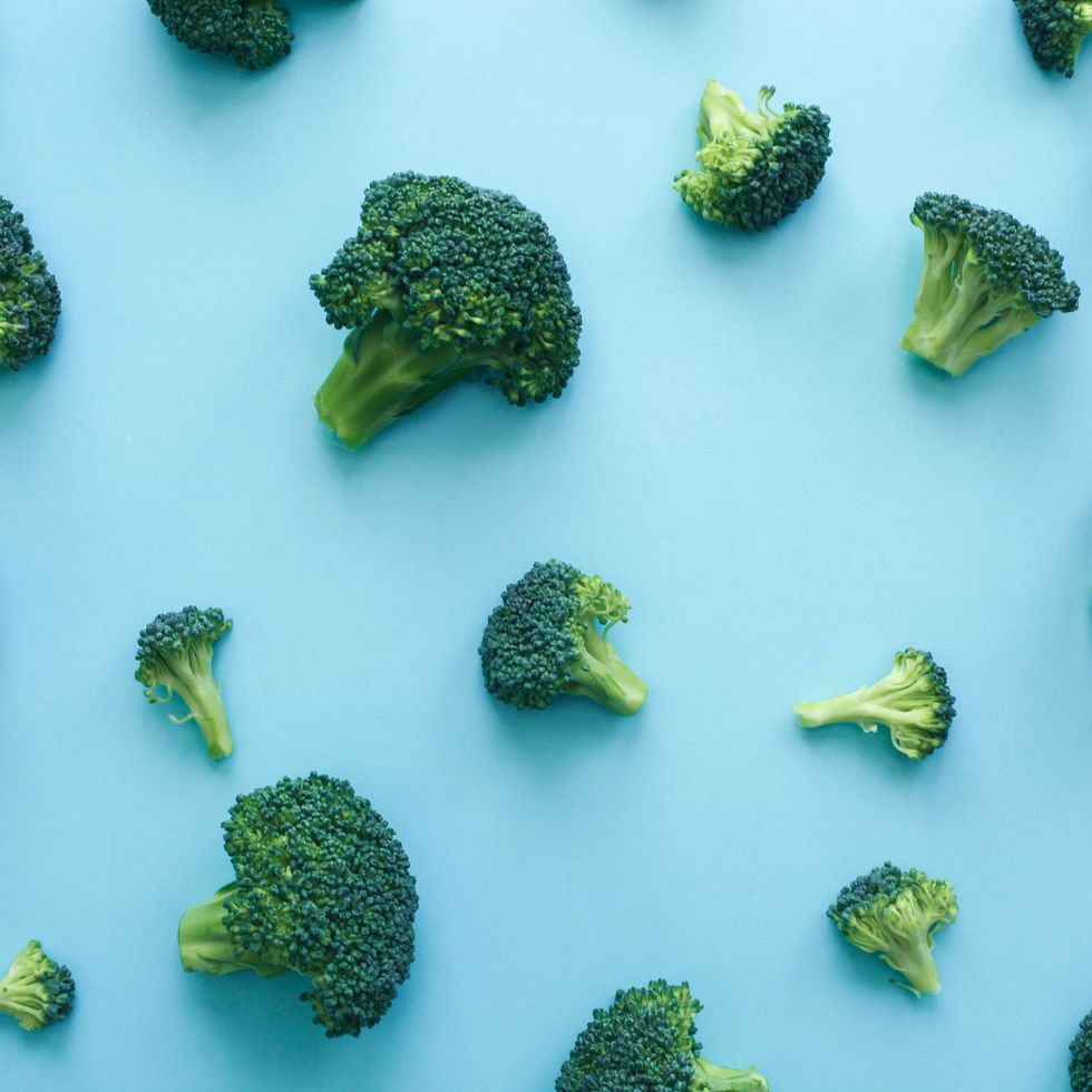pattern of fresh broccoli over blue background vegan healthy food