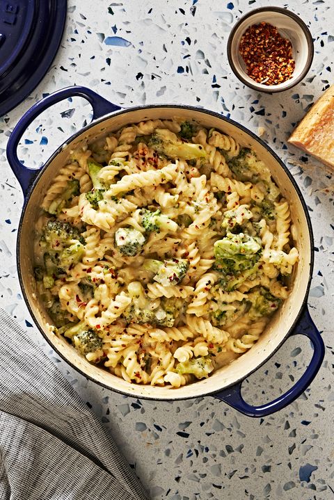 broccoli cheddar pasta in a navy blue dutch oven