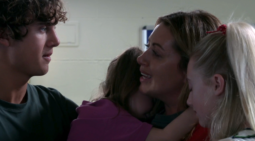 lou hugs her children brody, joanie and shanice on coronation street