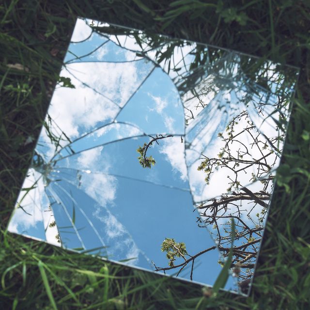 broken mirror on grass