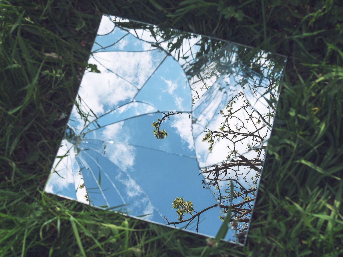 broken mirror on grass