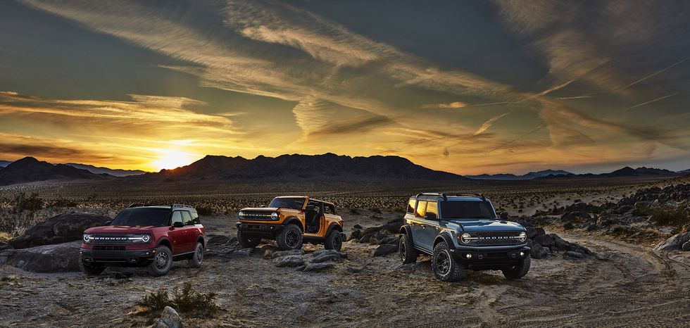 pre production versions of the all new 2021 bronco family of all 4x4 rugged suvs, shown here, include bronco sport in rapid red metallic tinted clearcoat, bronco two door in cyber orange metallic tri coat and bronco four door in cactus gray