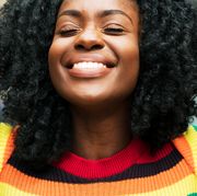 woman in rainbow shirt smiling