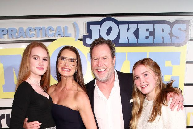 rowan henchy, brooke shields, chris henchy, and grier henchy pose for a photo, everyone is smiling and hugging and wearing black or white outfits