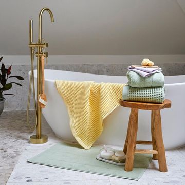 a bathtub with a towel and towels on it