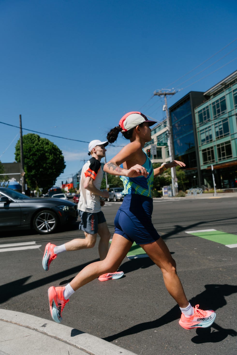 two runners crossing the street in an urban environment