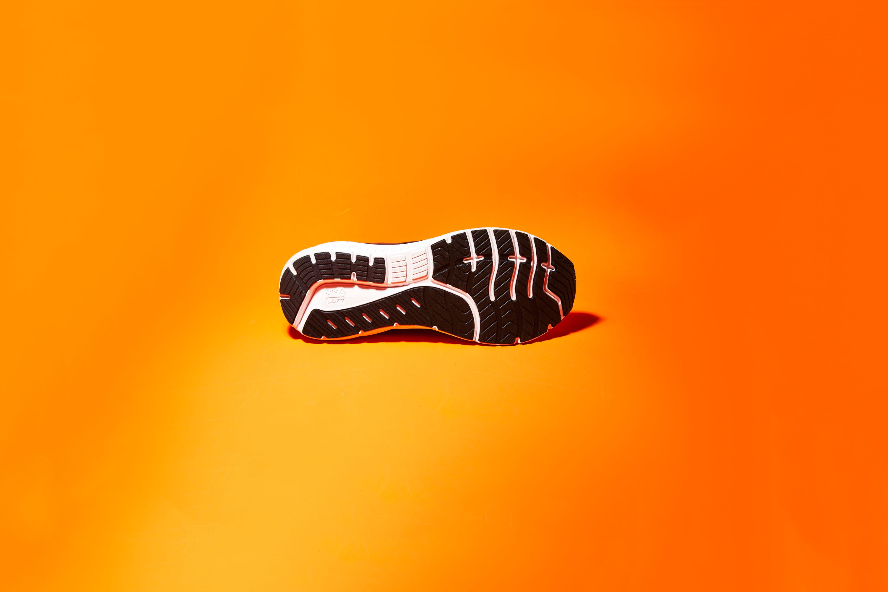 Orange, Footwear, Yellow, Shoe, Logo, Font, Athletic shoe, Graphics, 