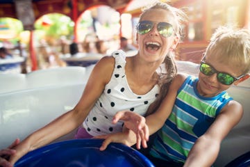 brother and sister enjoying spinning carousel