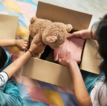 brother and sister packing clothes and toy in the donation box.