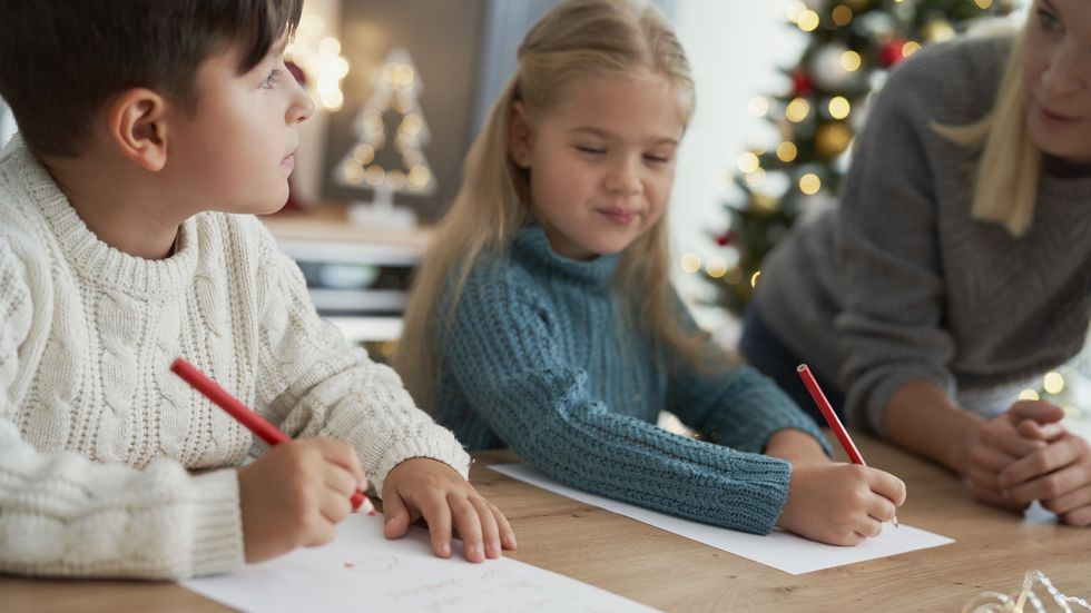 brother and sister writing a letter to santa claus