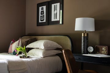 bedroom with brown wall and cane headboard