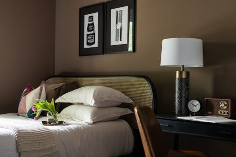 bedroom with brown wall and cane headboard