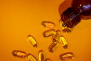 brown bottle of vitamins omega 3 pills