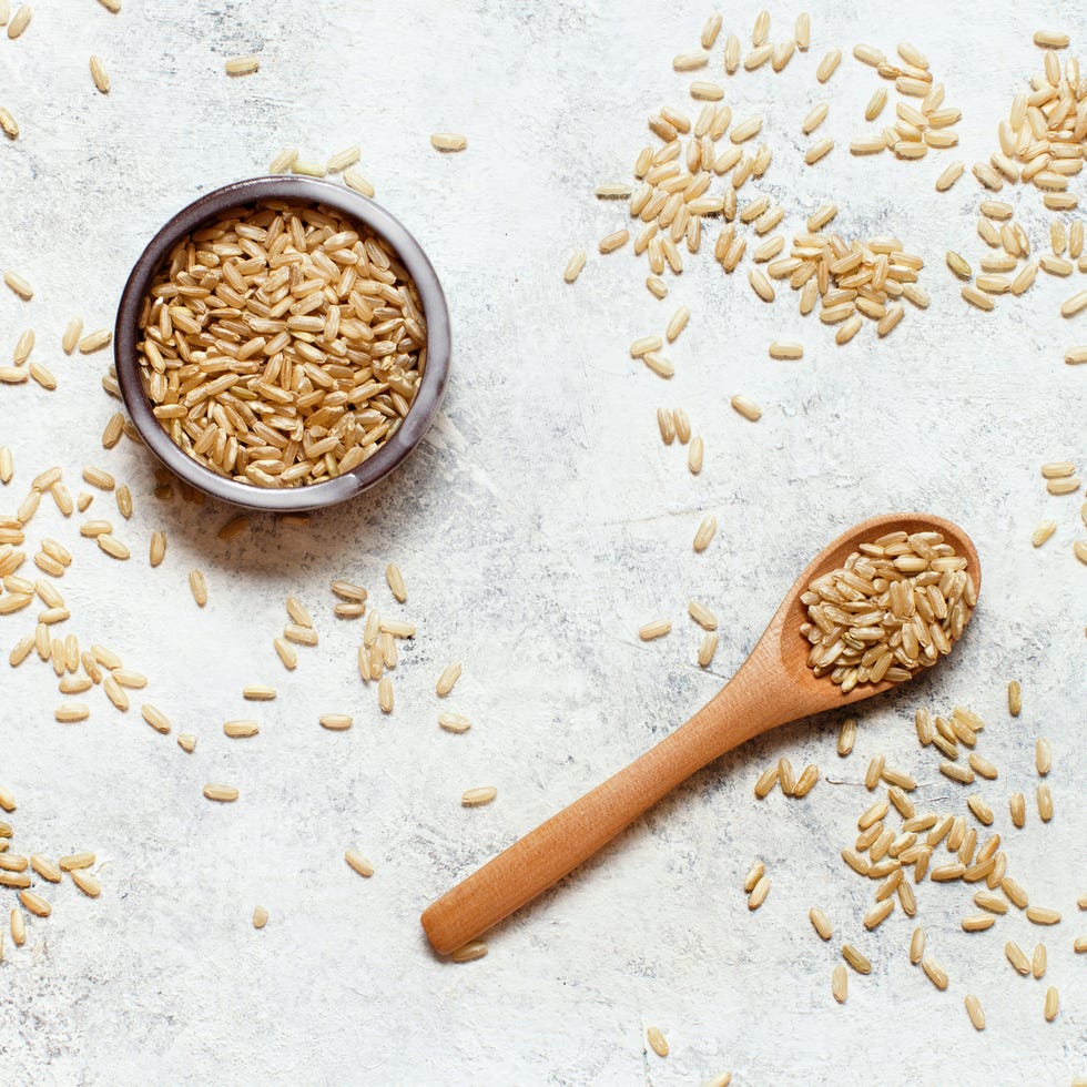 Brown rice in wooden bowl with spoon brown rice in wooden bowl with spoon