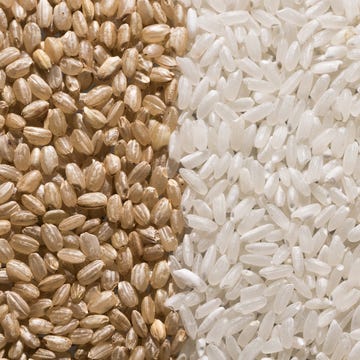 grains of raw brown rice next to grains of raw white rice