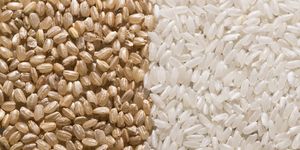 grains of raw brown rice next to grains of raw white rice