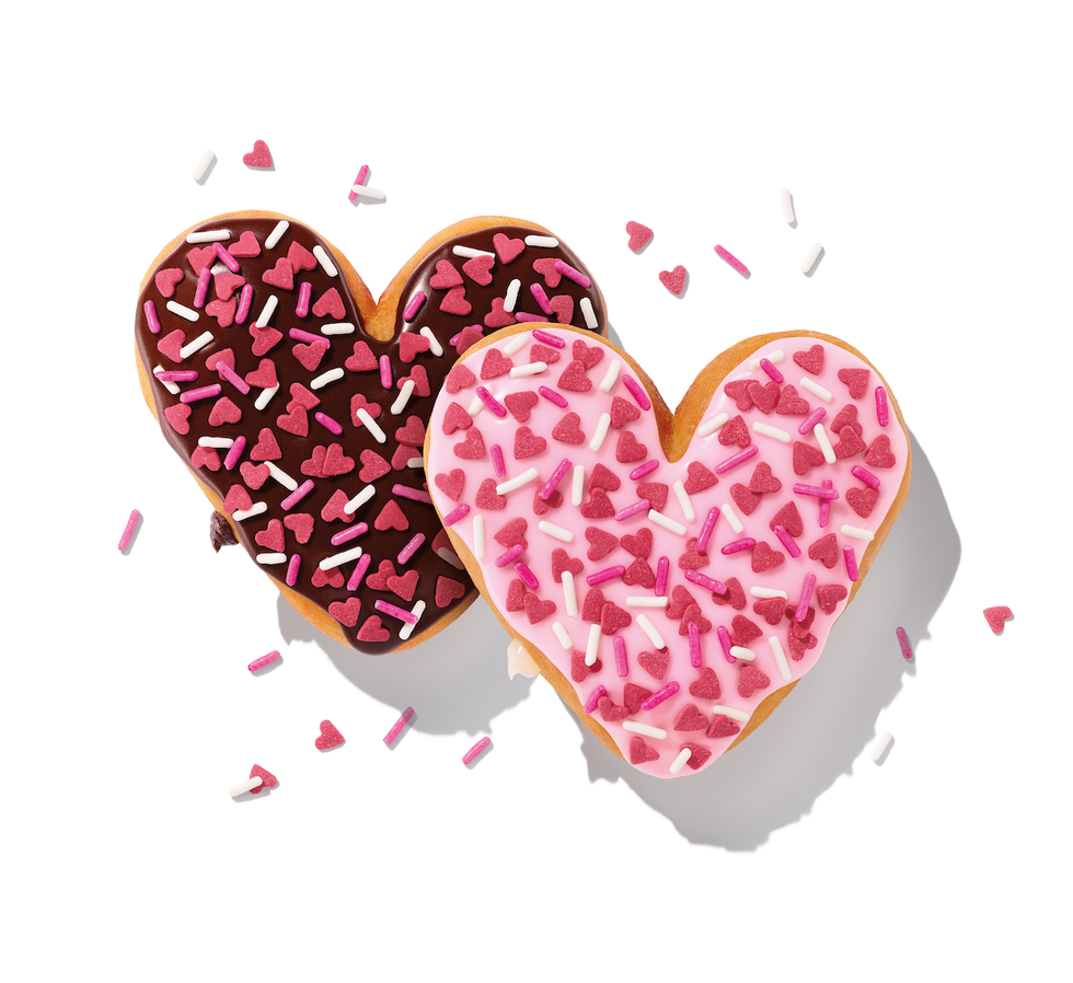 two heartshaped donuts with chocolate and pink icing adorned with colorful sprinkles