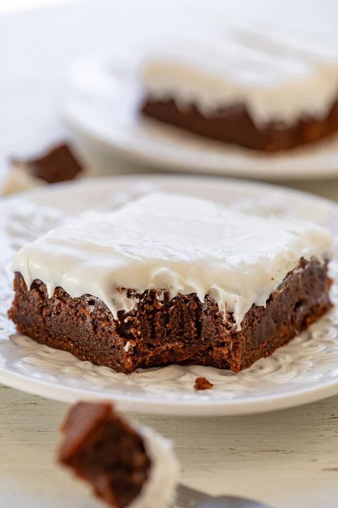 vanilla frosted brownies on white plate