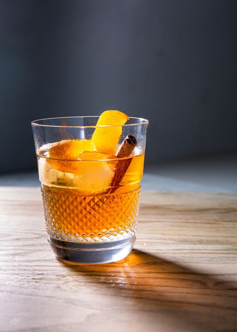 brown sugar old fashioned cocktail garnished with orange peel and a cinnamon stick in a glass