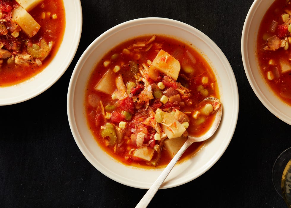 brunswick stew in a white bowl with a spoon