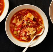 brunswick stew in a white bowl with a spoon