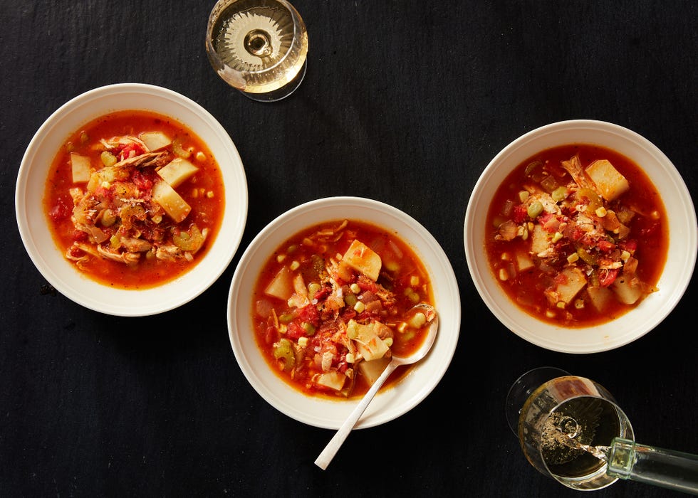 brunswick stew in a white bowl with a spoon