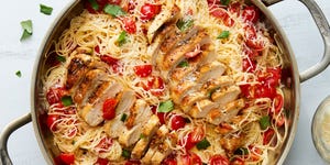 bruschetta chicken pasta topped with fresh herbs and parmesan