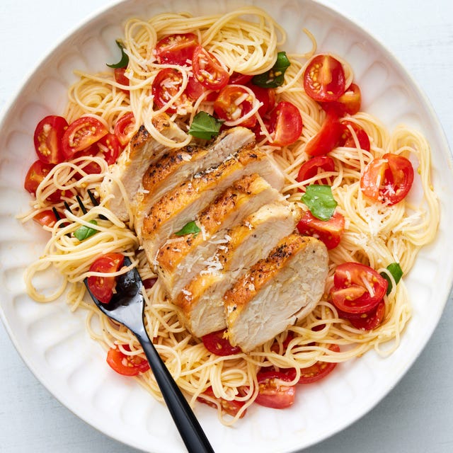bruschetta chicken pasta topped with fresh herbs and parmesan