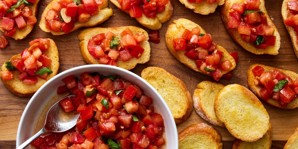 bruschetta spooned on top of slices of a toasted baguette