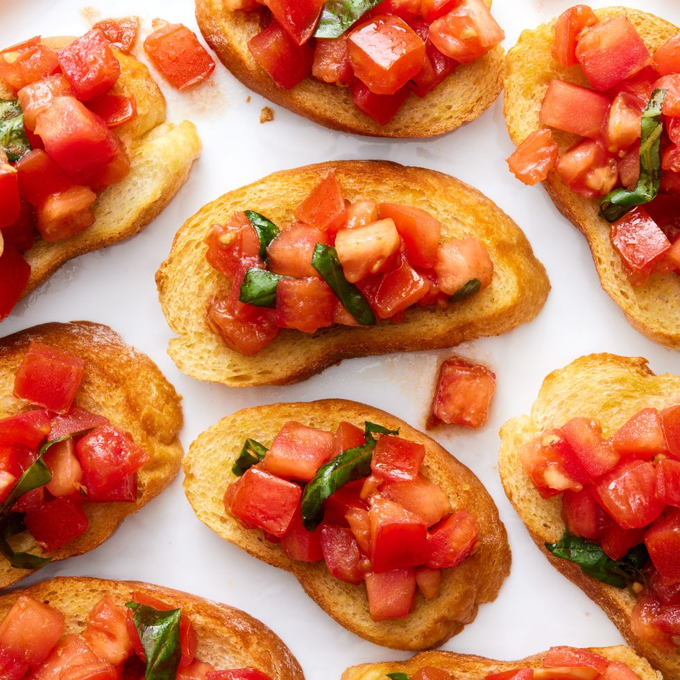 bruschetta spooned on top of slices of a toasted baguette
