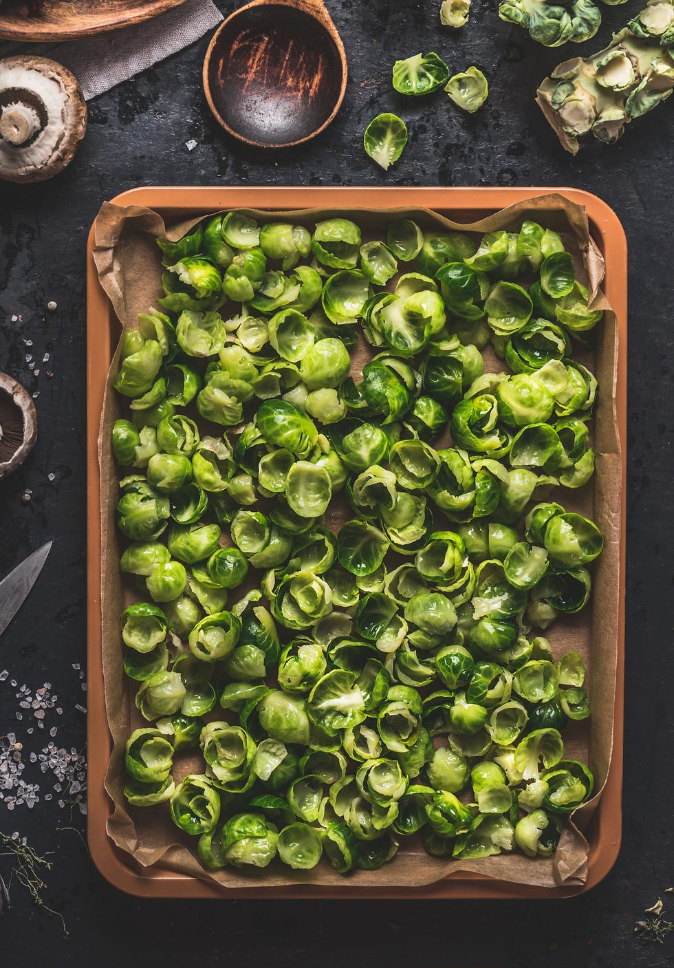 Brussels sprouts leaves on baking sheet, top view