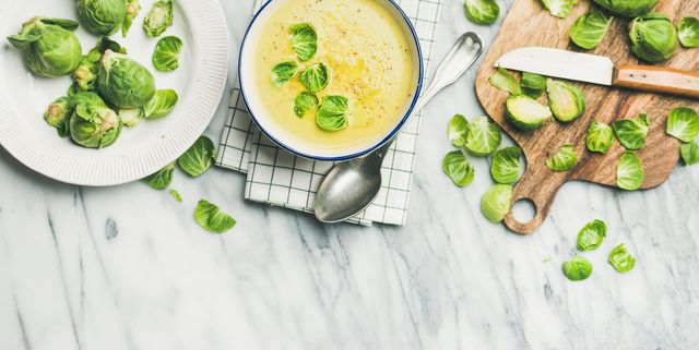 Brussels sprouts vegetable cream soup and fresh green brussel sprouts