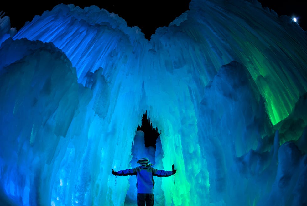 A person standing in a large ice cave