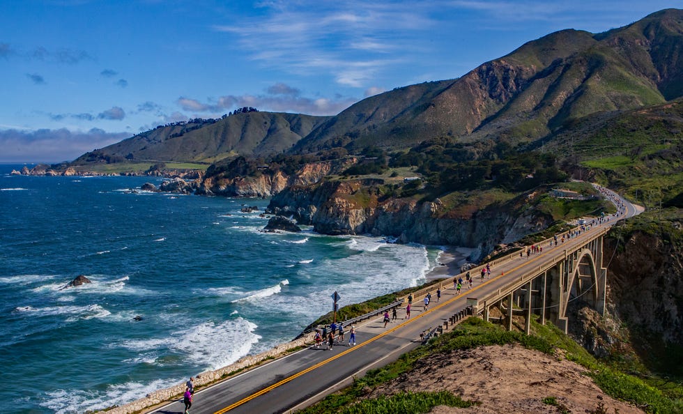 runners on road along ocean at big sur marathon