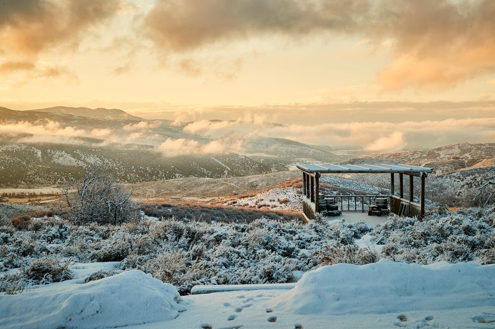 a snowy landscape with a building in the distance