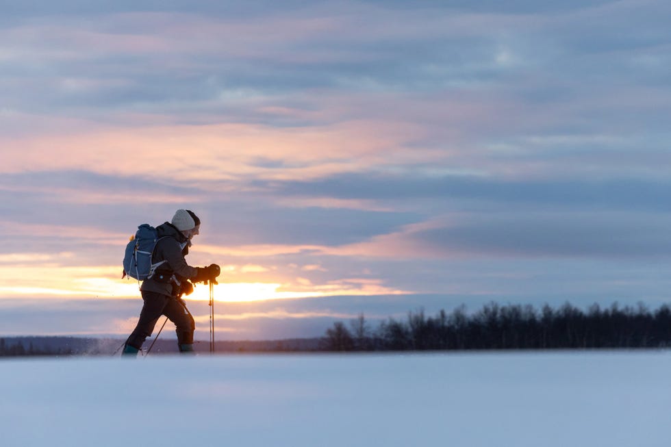 two people trekking across ice