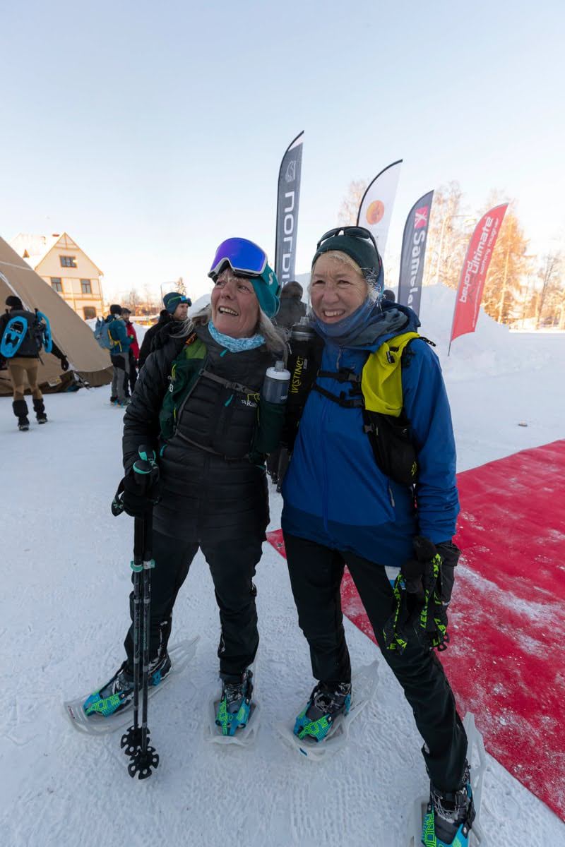 two women standing on ice and smiling