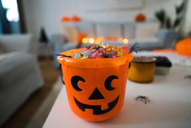 bucket in a pumpkin shape, full with candy