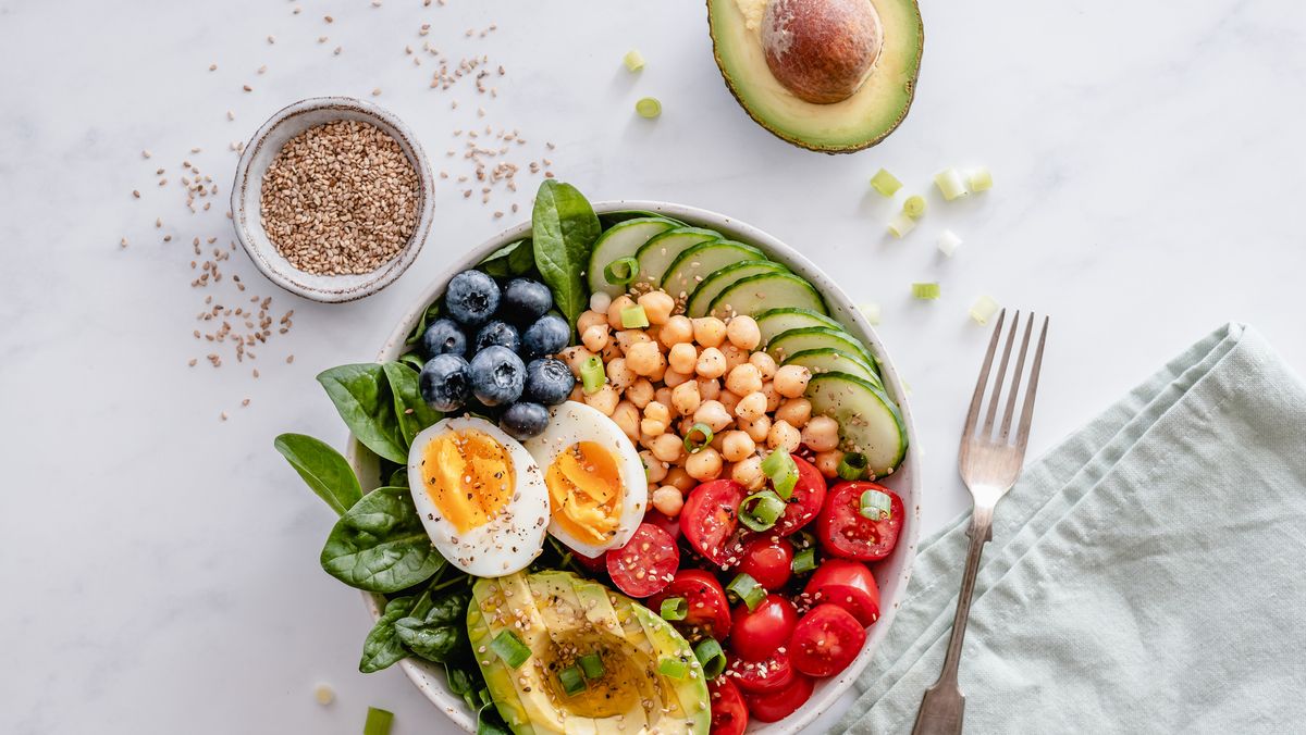 https://hips.hearstapps.com/hmg-prod/images/buddha-bowl-with-avocado-egg-chickpeas-tomato-royalty-free-image-1666125561.jpg?crop=1xw:0.84415xh;center,top&resize=1200:*