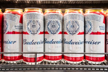 budweiser beer cans displayed for sale in a supermarket