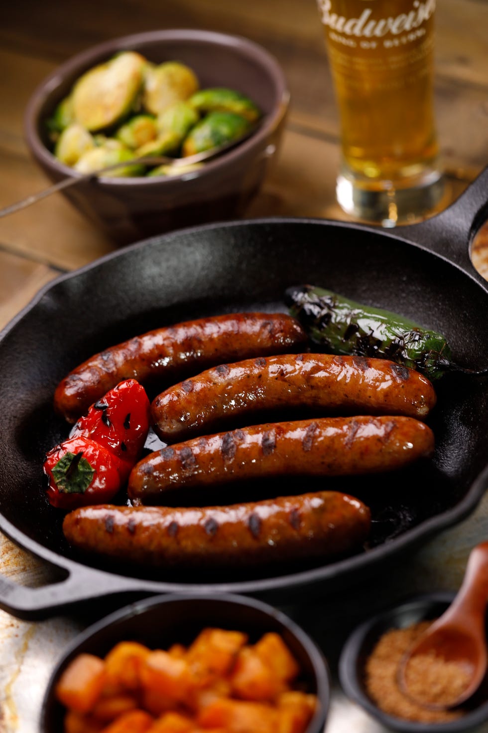 Packaging photos of Budweiser/Niman Ranch co-branded ribs, brats and pulled pork