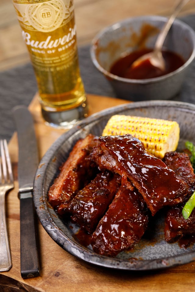 Packaging photos of Budweiser/Niman Ranch co-branded ribs, brats and pulled pork