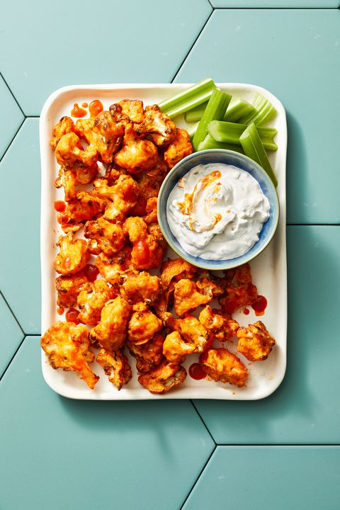 air fryer buffalo cauliflower bites with a dipping sauce on the side